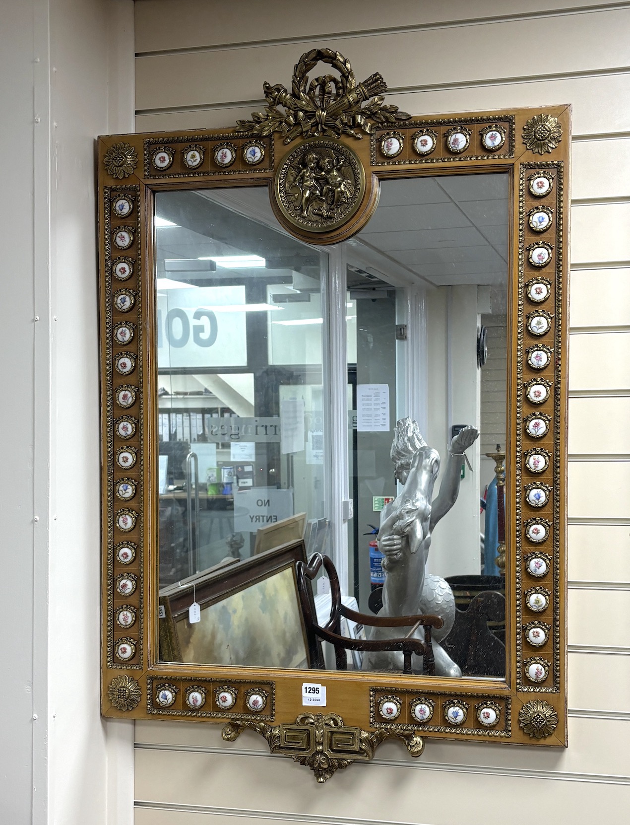 A Louis XVI style ormolu mounted wall mirror applied with porcelain plaques printed with flowers, width 78cm, height 118cm